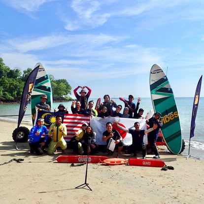 Beach guards with windsurf boards and flags