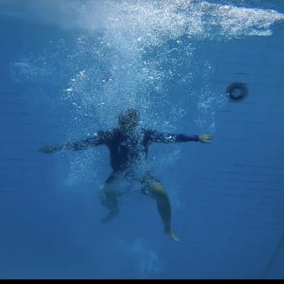 Diver descending through a cloud of bubbles