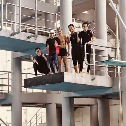 Divers posing on the high dive platform