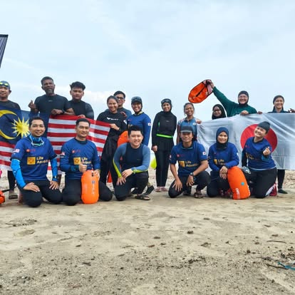 Malaysia and Japan flags raised on the sand