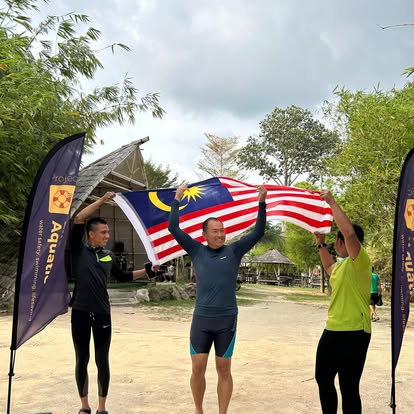 Raising the Jalur Gemilang between project banners