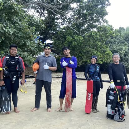 Scuba team gathered on the beach with gear