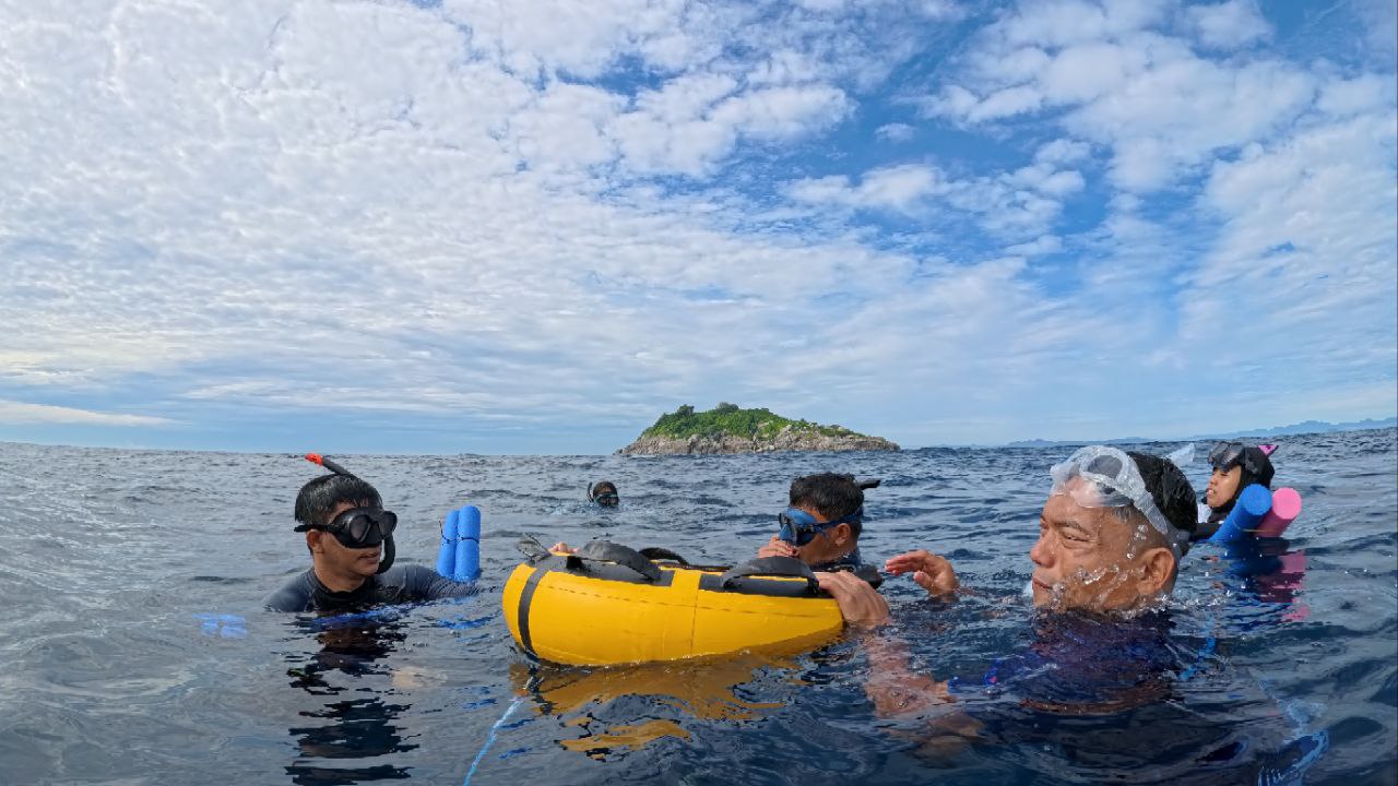 Snorkel group resting beside the island