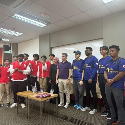 Team and partners gathered after a briefing