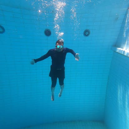Diver hovering underwater in the training pool